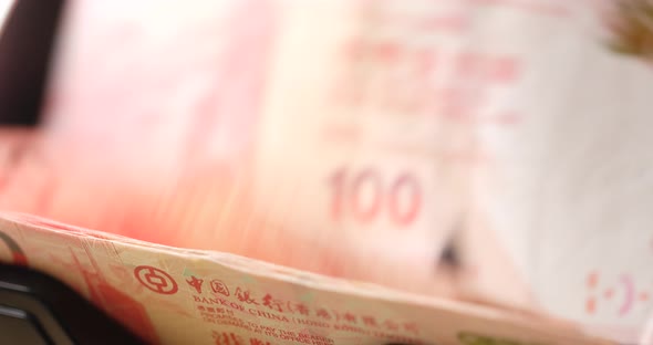 Hong Kong dollar banknote on counting machine close up alt