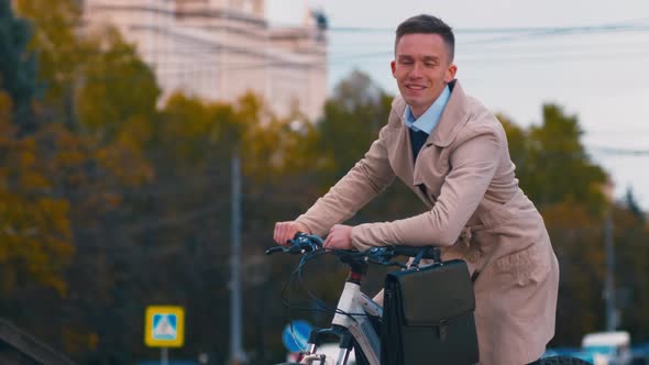 Successful businessman on bicycle outside alt