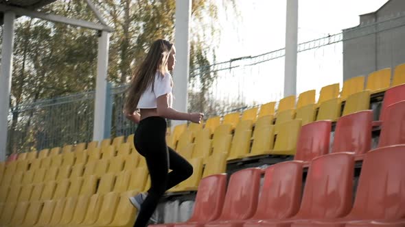 Young Fit Asian Runner in Sportswear Running Up the Ladder of Tribune at Stadium
