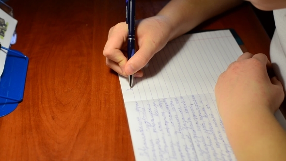 The Boy Writes In Notebook Homework On  Russian Language