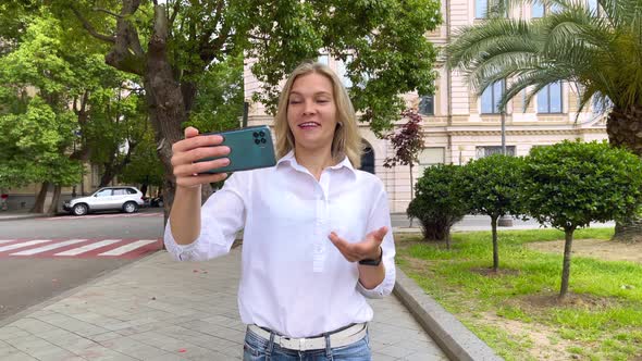 Blogger with Smartphone in the City