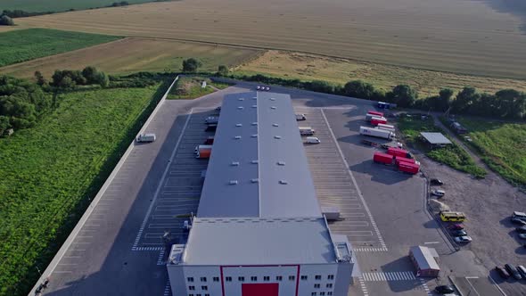 Trucks in the Parking Lot Near Warehouse alt