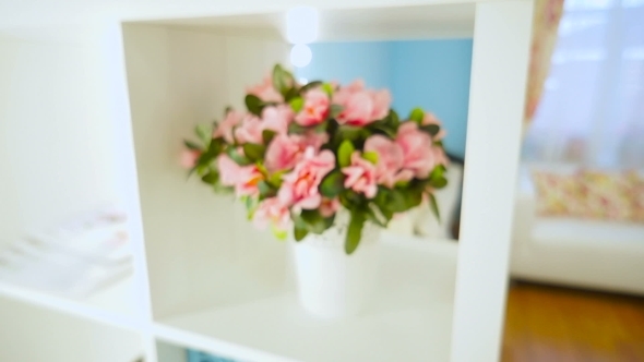 Bouquet Of Artificial Flowers In a Pot On The Shelf