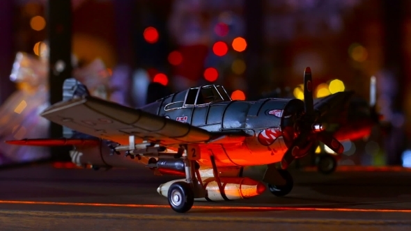 Toy Plane Is On The Shelf Amid Flashing Colored Lights
