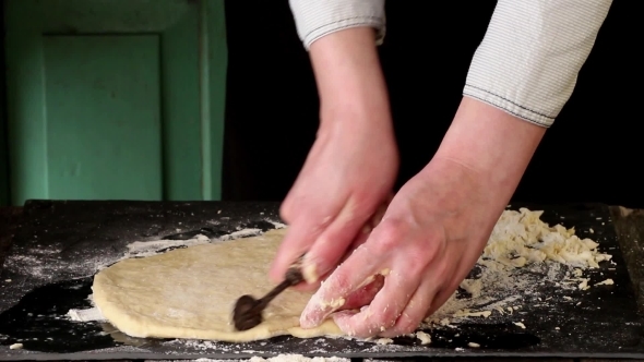 Female Hands Slicing Dough For Pasta By Vintage Roll Over Black Table