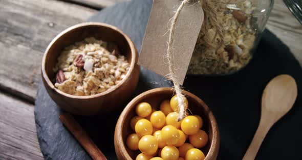 Bowl of cape gooseberry and jar of muesli on a table 4k alt