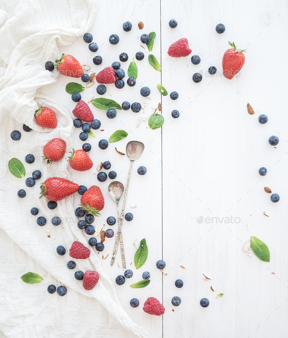 Berry frame with copy space on right. Strawberries, raspberries, blueberries and mint leaves - Stock Photo - Images