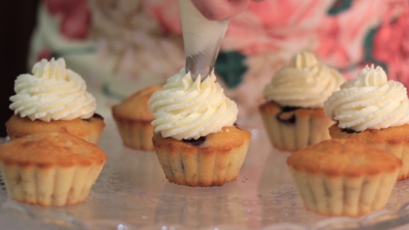 Whipped Cream Frosting Applied To Berry Cupcakes