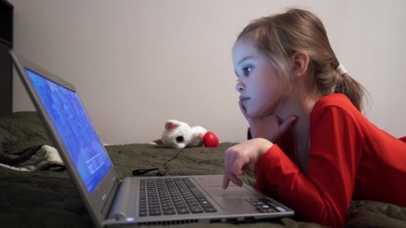 Little Girl At Night Watching Cartoons At Computer