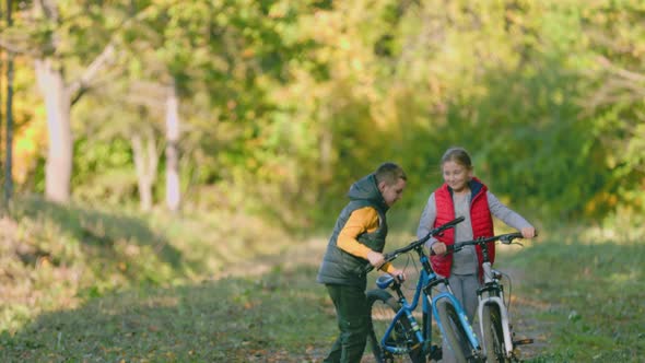 Children Walk with Bicycles