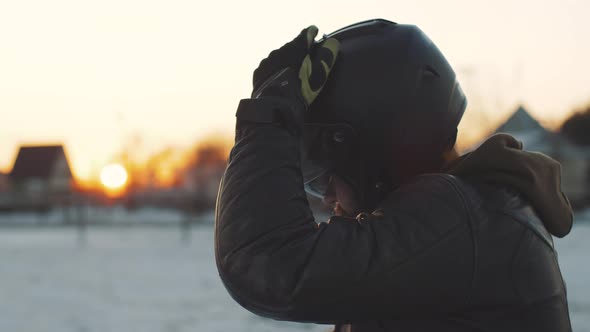 Man Rides a Motorcycle in Cold Winter alt