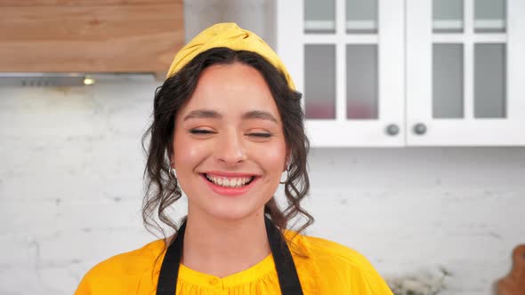 Close Up Smiling Housewife Looking at Camera in Home Kitchen alt