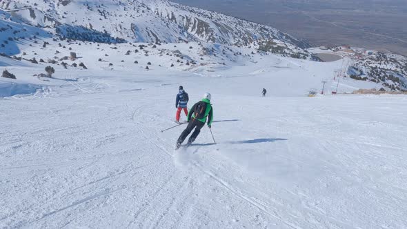 Two Sports Man Skiers Skiing In The Mountains On A Ski Resort Downhill