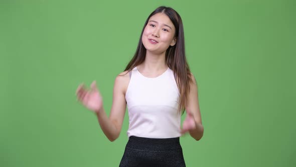 Young Beautiful Asian Businesswoman Clapping Hands