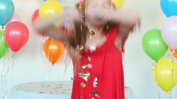 Girl with Ponytails Throws Confetti Celebrating Birthday alt