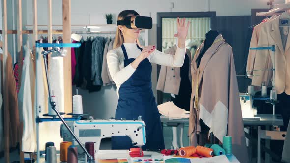 A Dressmaker is Using VRdevice While Working in the Studio alt