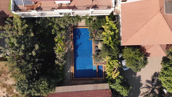Ascending Drone Shot of a Tropical Hotel Grounds and Swimming Pool alt