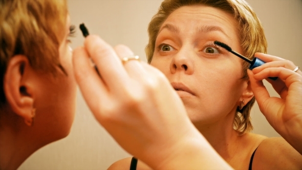 Pretty Blond Woman Applying Mascara Make-up