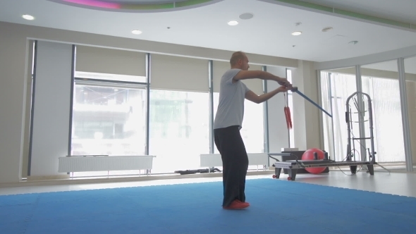 Young Man Practising Kungfu In Gym