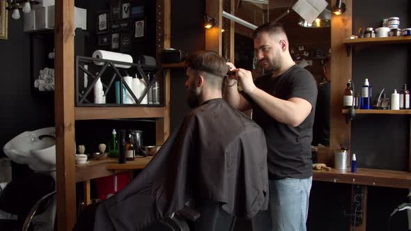 Barber Cutting Hair of Male Client