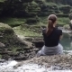 Girl Sitting Near a Mountain River - VideoHive Item for Sale