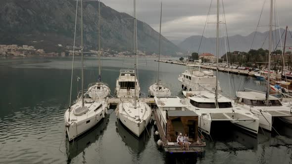 Aerial view of man and a woman sitting and drinking tea sitting on a boat alt