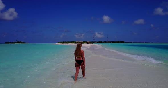 Beautiful happy ladies travelling in the sun at the beach on paradise white sand and blue background alt
