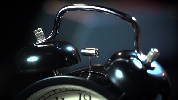 Ancient Desktop Alarm Clock On a Black Background 