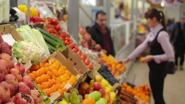 The Seller And The Buyer Talk At The Counter With The Fruits
