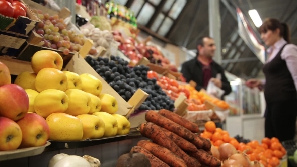 Woman Buys Vegetables At a Farm Market