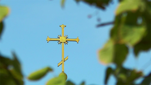 The Cross on the Dome Among Leaves