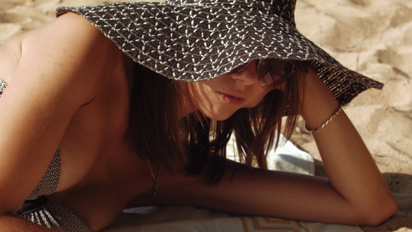 Young Sexy Woman In Bikini Reading Book At The Beach