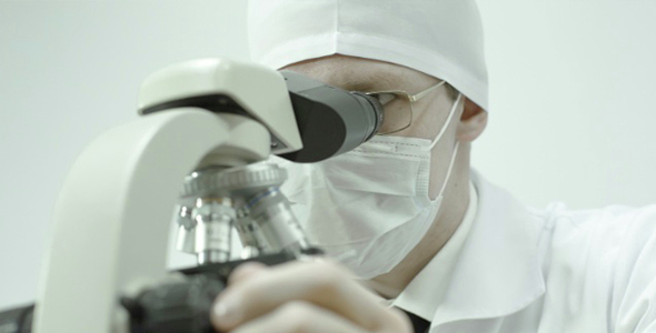 Physician Looks Through a Microscope alt