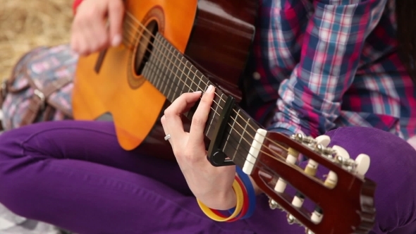 Girl Composes Music With a Guitar