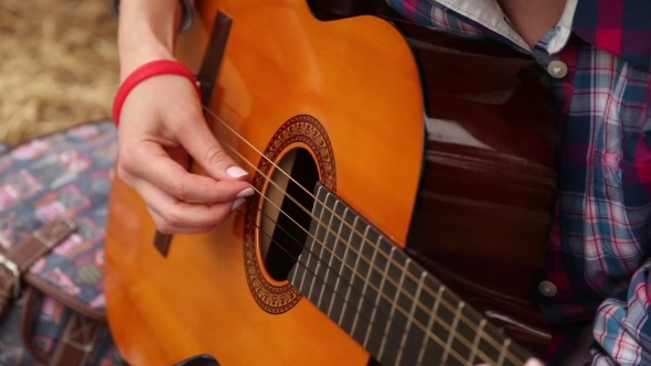 Girl Composes Music With a Guitar.