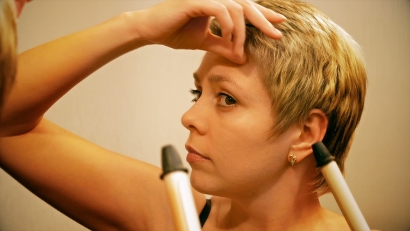 Short Hair Woman Curls Her Hair With Curling Iron