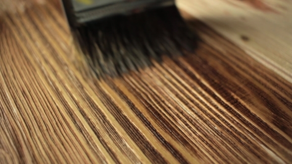 Wood Painting With a Brush With The Brown Color