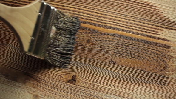 Wood Painting With a Brush With The Brown Color