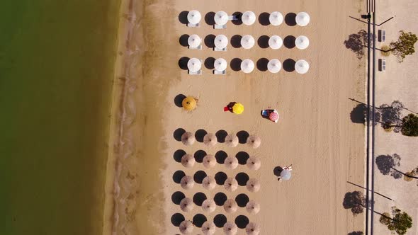 View from above, aerial view of an amazing beach with beach umbrellas in Albania
