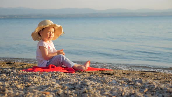 Seascape with Baby Eyes, Little Girl Sitting on the Coast and Looking on Seascape, Summer Vacation