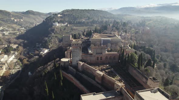 Amazing and unique shot of Alhambra fortress with mountains in background, Granada in Spain. Aerial
