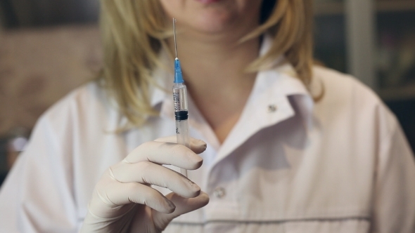 Woman Doctor Holding Syringe On Surgical Room  