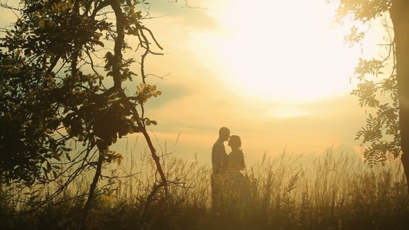Kissing At Sunset,two Lovers Kissing At Sunset