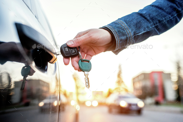 Woman with car key - Stock Photo - Images