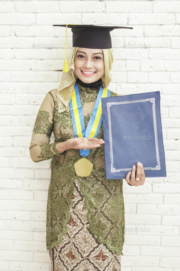 indonesian female graduated student in traditional clothes smili