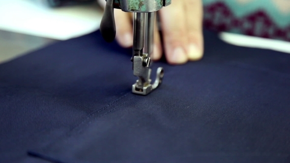 Woman Sews Clothes In  Workshop