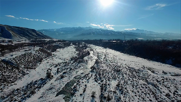 Aerial Flight Above the River in Winter