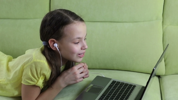 Emotional Little Girl Talking On Skype At Laptop alt