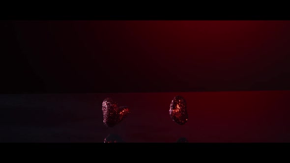 Valentine's Day decorations falling and bouncing on a reflective surface - VALENTINES 006 alt