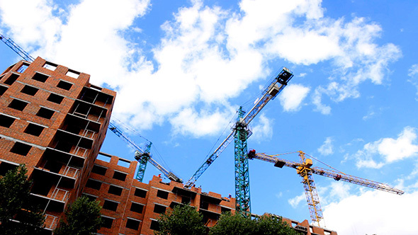 Tower Cranes Building a House